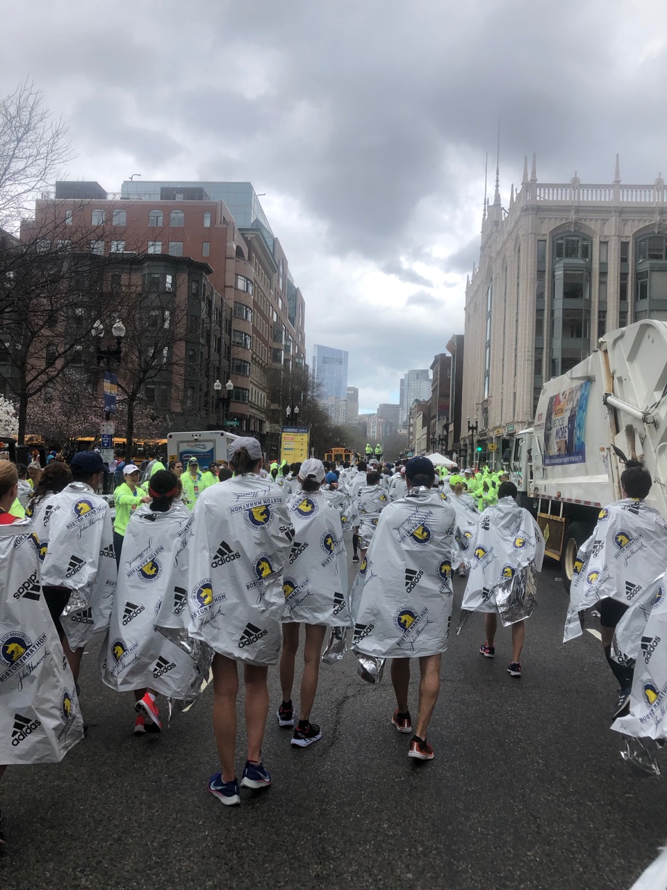 Runners walking off, wrapped in space blankets