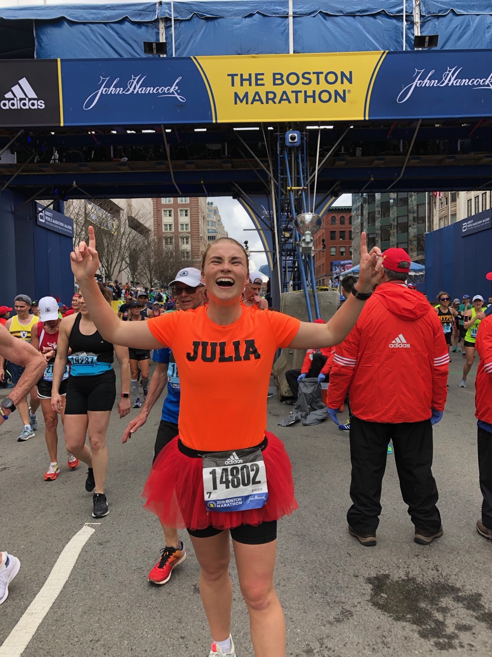 Happy at the finish line with fingers pointing up